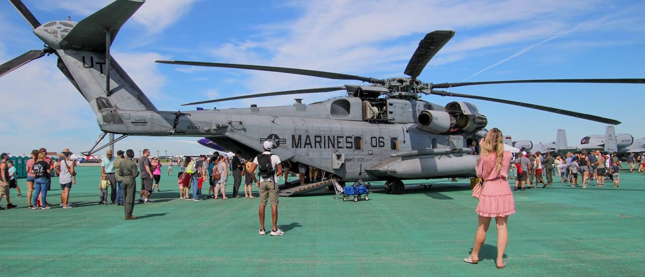 U.S. Marine Corps helicopter with people around it.